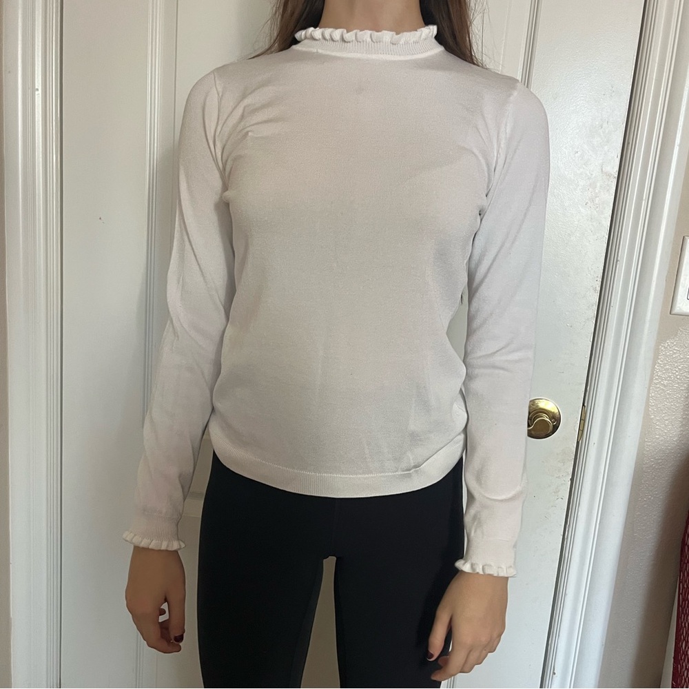 white turtleneck with ruffled neck